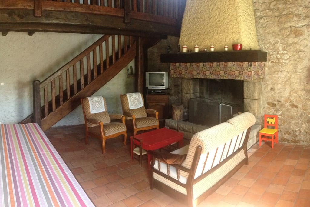 Living room with chimney and table for 10 people