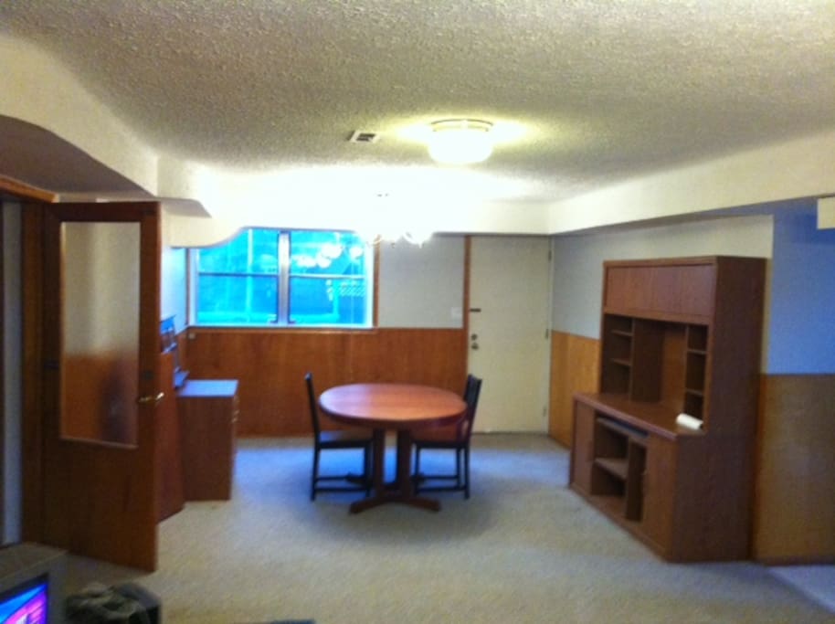 living room with a large window to the backyard