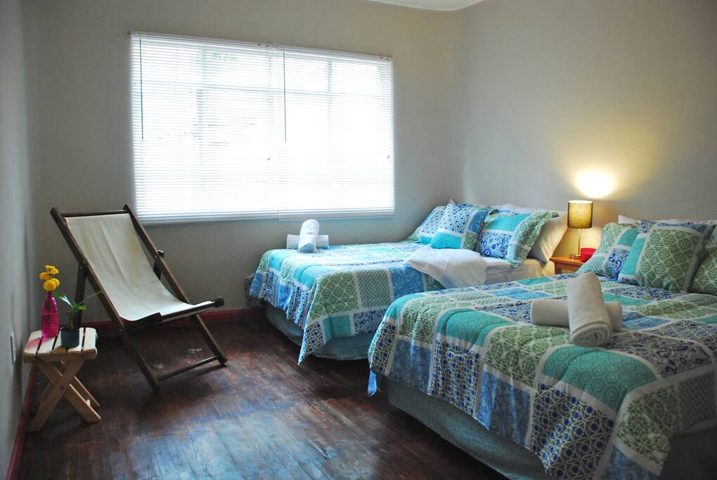 -Pink Room-
2 Queen beds
Clothes space
Comfy colourful Chair