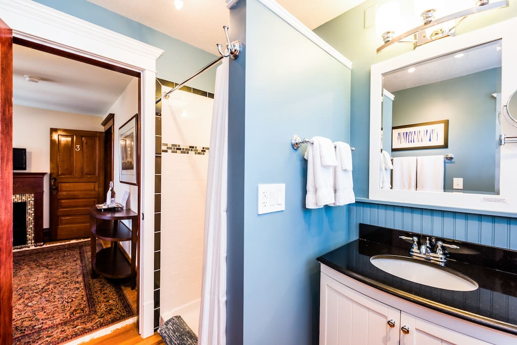 A private ensuite bathroom offers absorbent towels, make-up remover, magnifying mirror, hair dryer, shampoo, conditioner, soaps and other guest amenities.