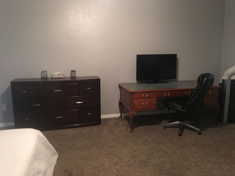 Dresser, desk and Tv shown