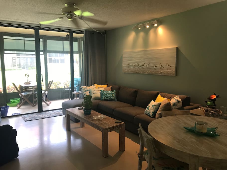 This modern living room features a comfortable sofa sectional and provides ample seating for you and your guests.