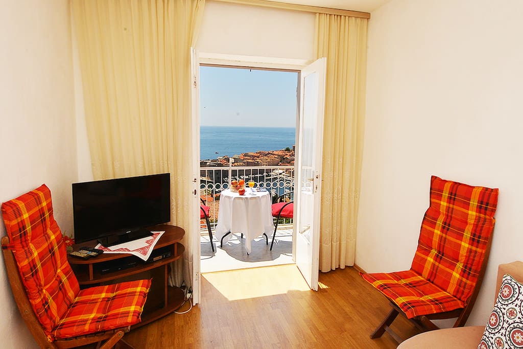 living room with balcony overlooking the old town and islands