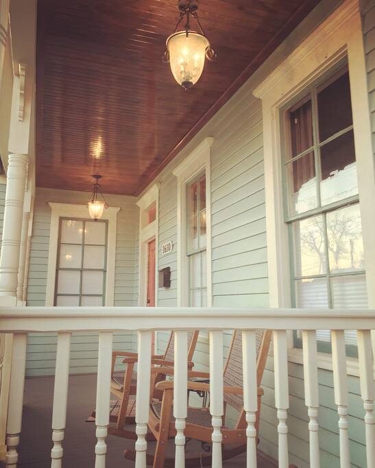 Front porch is perfect for sitting in the rocking chairs and enjoying a glass of wine or a cocktail. Beautiful stained wood ceiling with cast iron lights.