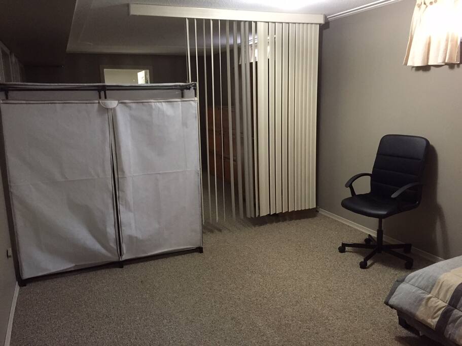 partition of this room is made by blinds and closet