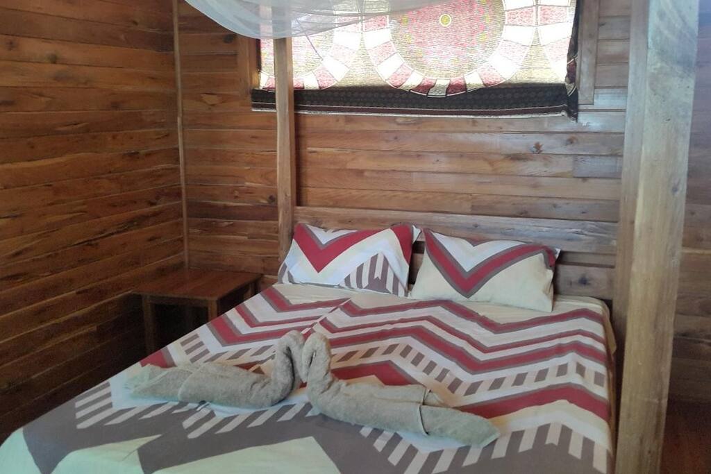 Room with queen size bed and en suite bathroom
