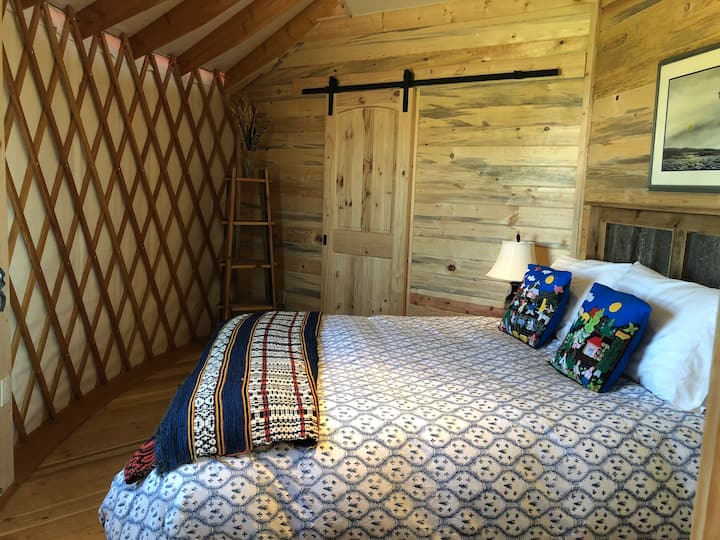 Bedroom facing west with barn door entrance to the bathroom