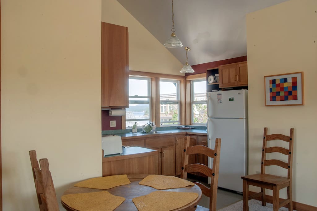 Kitchen with full sized refrigerator.