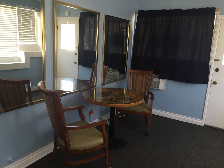 Bright room with AC & a table to eat, work or write.