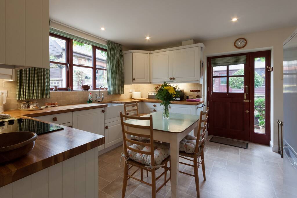 The light and airy kitchen opens on to a shared courtyard, with large picnic bench.
