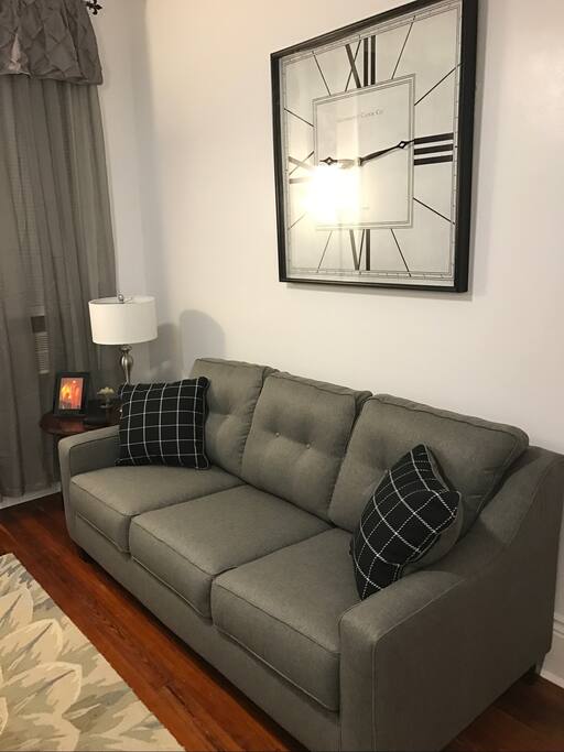 Living room with queen size sofa sleeper. flat screen tv, easy access to kitchen, dining area