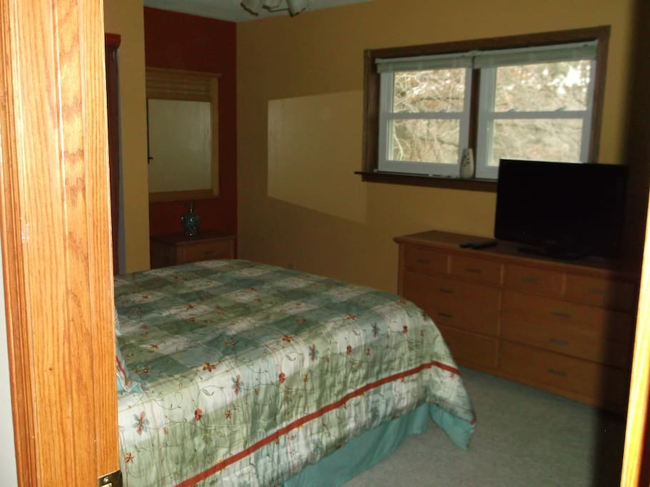 Master bedroom on main level. This room has a queen bed. There is a master bath with a walk in shower
