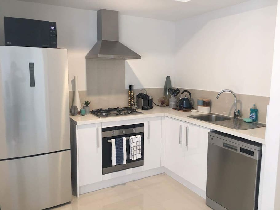 Modern kitchen, stone bench tops, cooking appliances all available