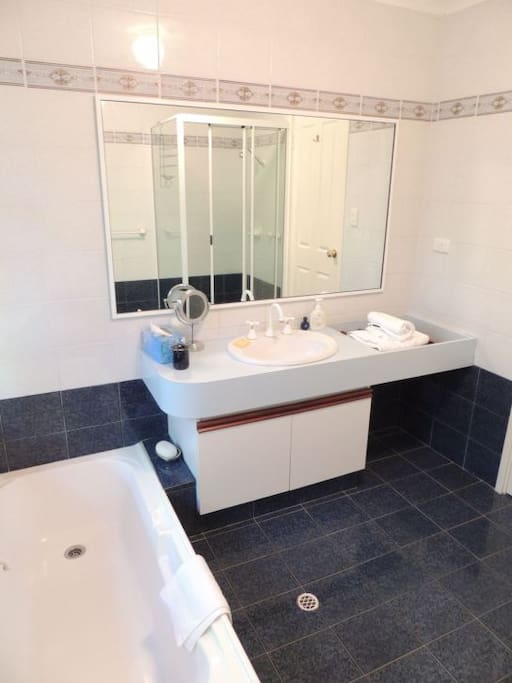 Private ensuite bathroom with toilet, shower and bath