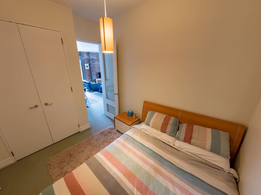 Medium sized room, queen bed, side table/drawers/ fitted wardrobe out of shot, window to corridor not outside (only this and 1 other apartment use the corridor)