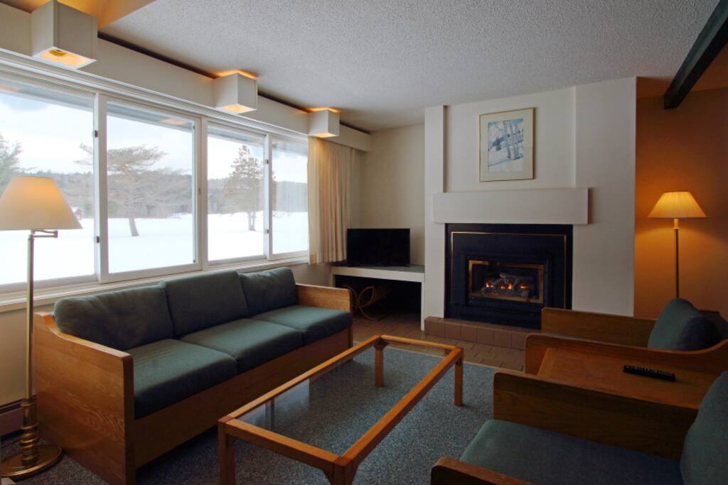 Living room with propane fireplace and views of Stowe Country Club greens.