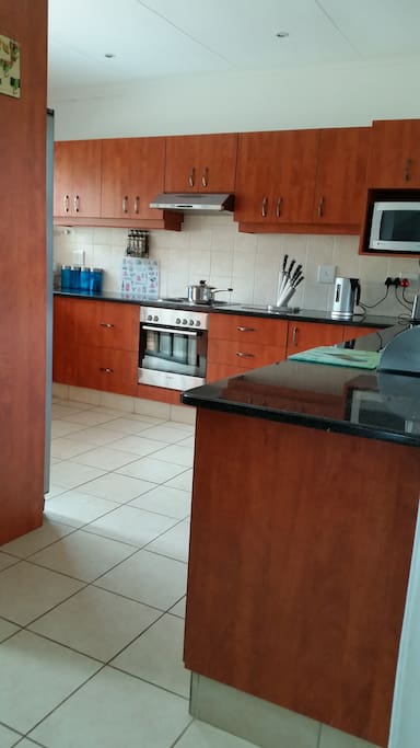 This is the kitchen area, which has a back door which leads to a space for making braai/barbecue.