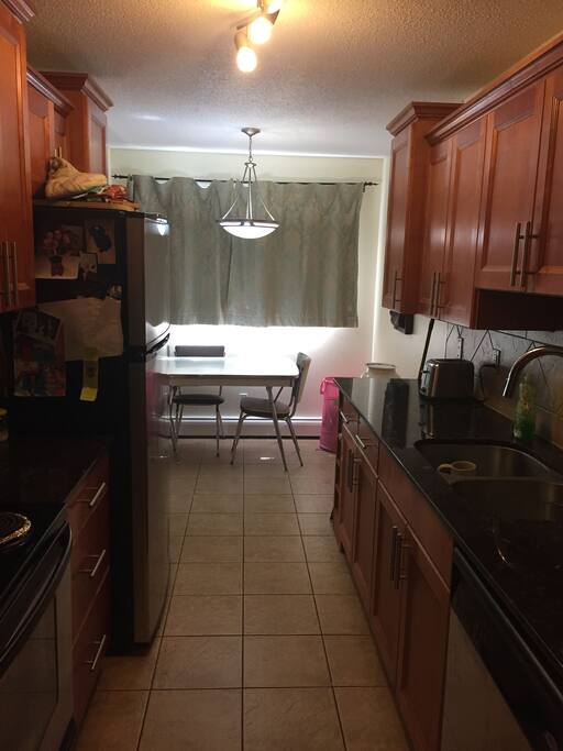 Kitchen has all granite countertops and stainless steel appliances.