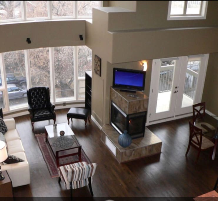 Bright living space and dining area, with super high ceilings and access to balcony.