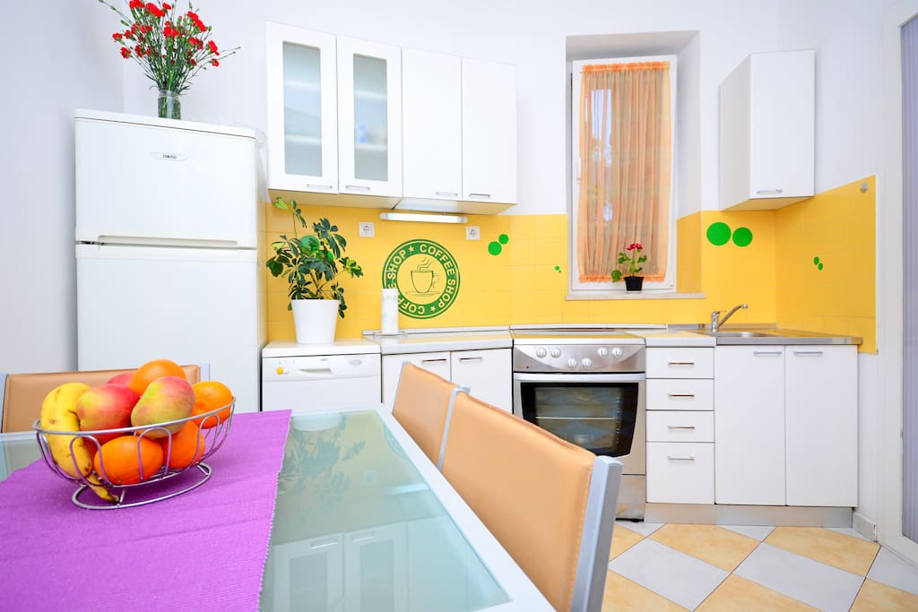 Kitchen with all supplies: refrigerator, dishwasher, kitchen stove and oven..