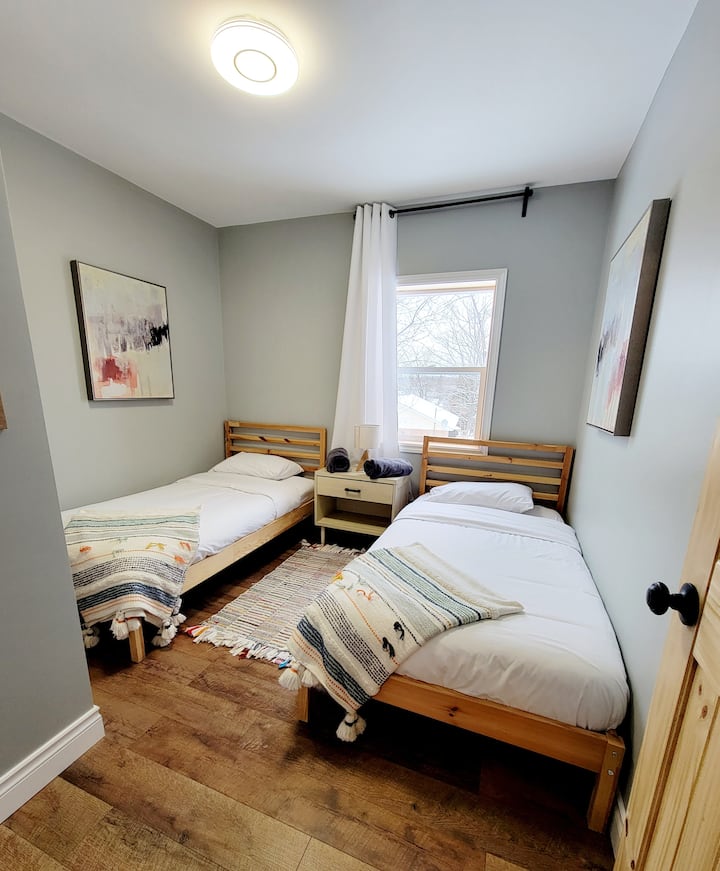 Bedroom #2 with 2 single beds and a closet.