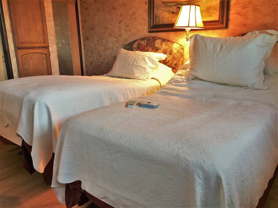 Beds are high-end Orthomatic adjustable beds. Bed on left shows feet elevated, bed on right show head elevated. Beds also have vibrating massage and heated mattress pads. When joined as a king, the beds can be made with separate twin bottom sheets and a king top sheet to allow independent adjustment. Comfy!