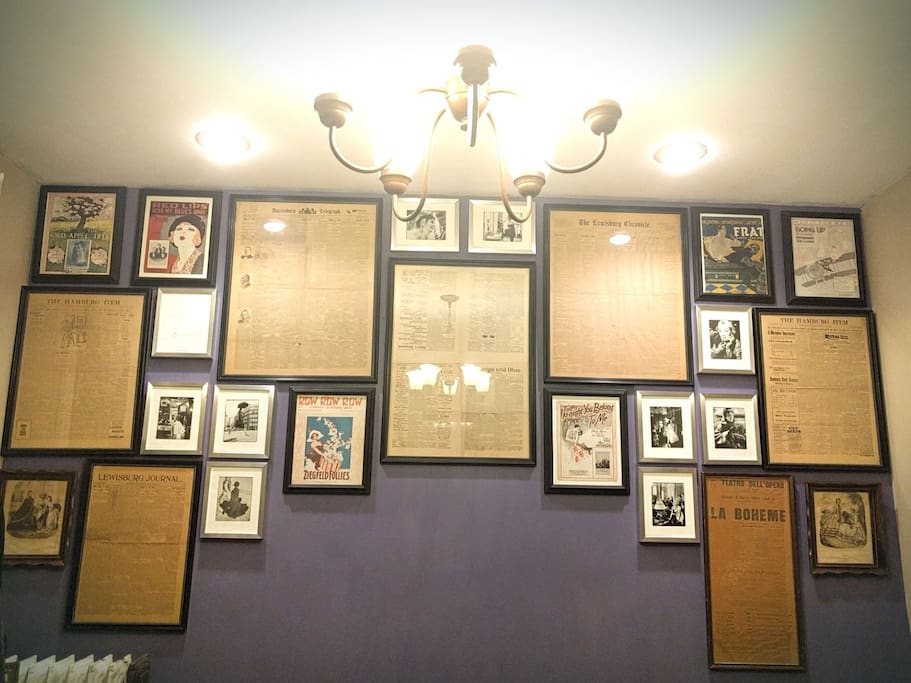 The Dining Room's feature wall of antique newspapers, Richard Avedon fashion plates and 1910-20s sheet music.