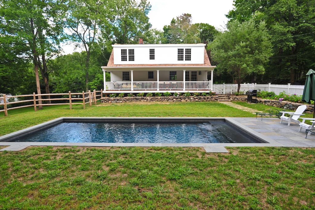 Wonderful private back yard, pool, bbq, covered dining porch with a flat lawn surrounded by stone walls.