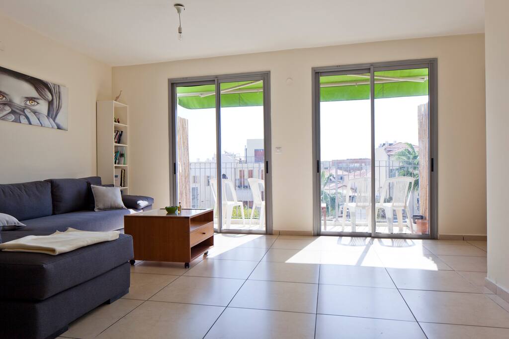 Large living room with balcony light and view.