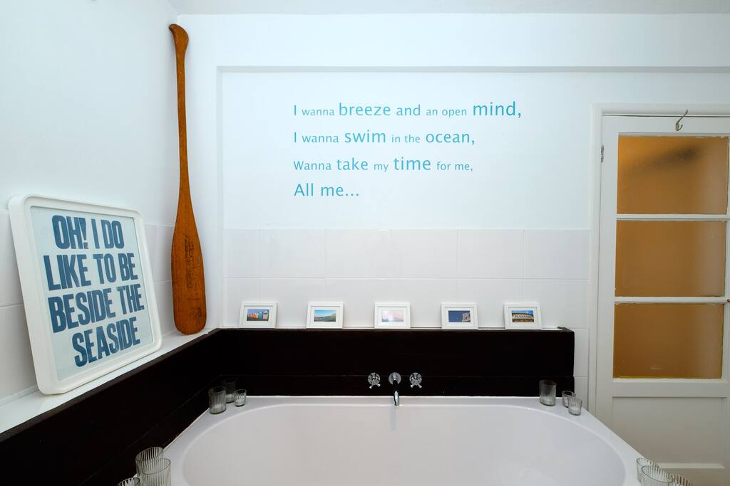 Nautical bathroom with bath and shower