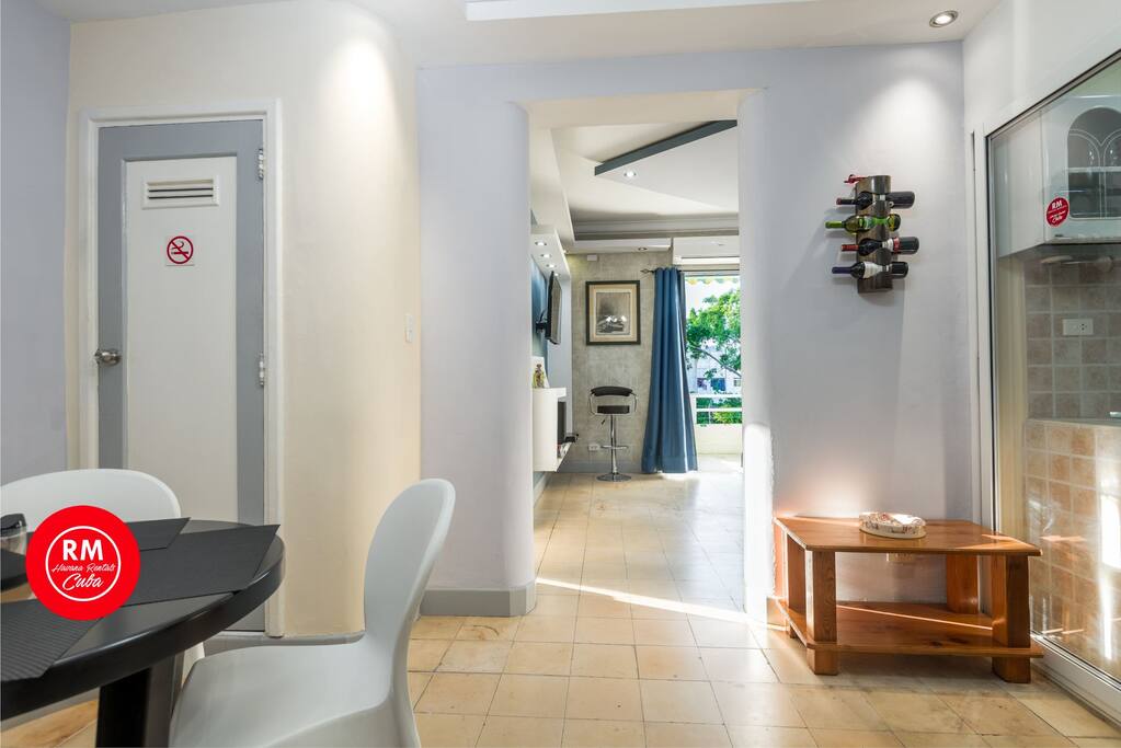 view of diner on the left and kitchen on the right, access to the balcony bedroom and living on the background.