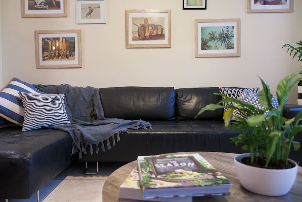 Spacious lounge with a seven seater couch and 55 inch tellie with sound bar and Apple TV