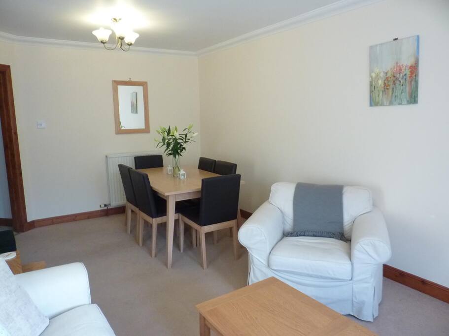 The dining table is in the dining area of the main sitting room.