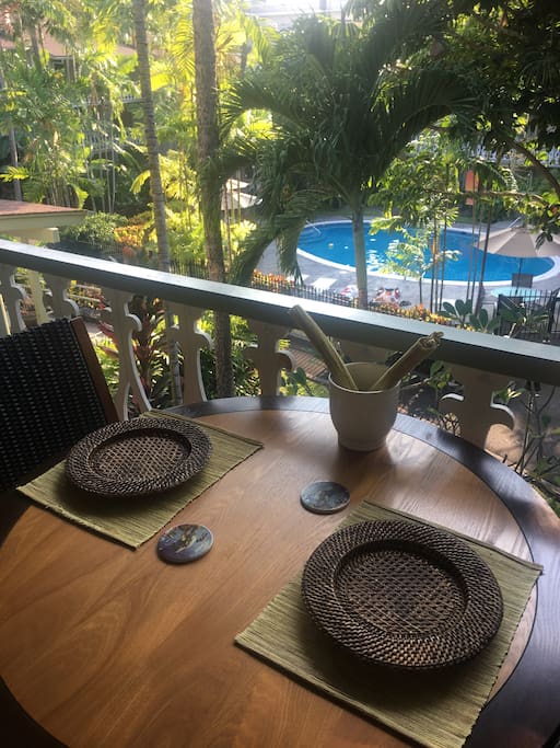 Outdoor dining on private patio overlooking the pool
