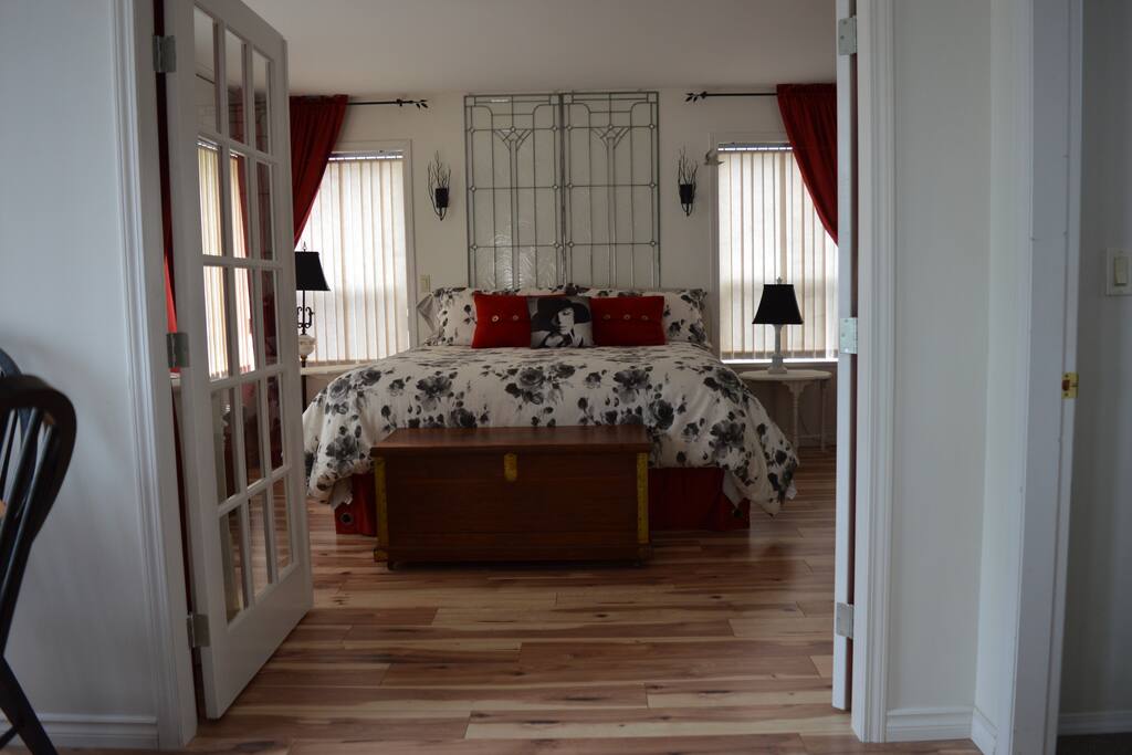 Garden Suite Master Bedroom with king size bed and exterior door.