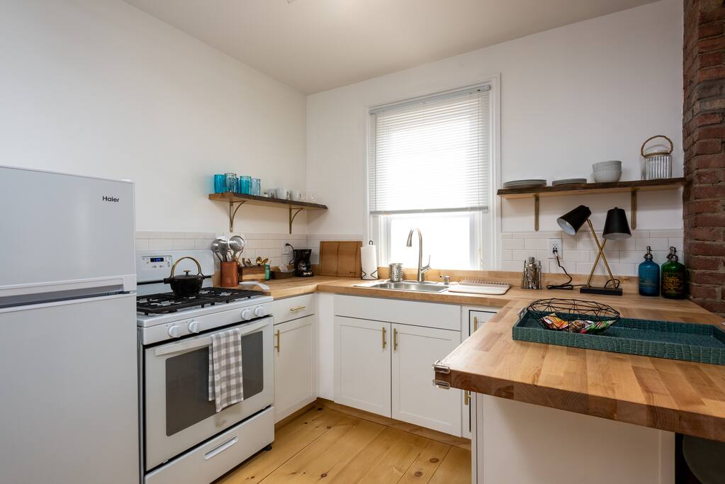 Full brand- new sparkling kitchen with coffeemaker and cast iron kettle.