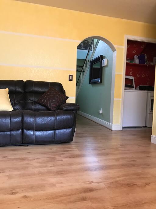 Shared living space...Sitting area, leading to living room, with laundry room. 1/2 bathroom downstairs .