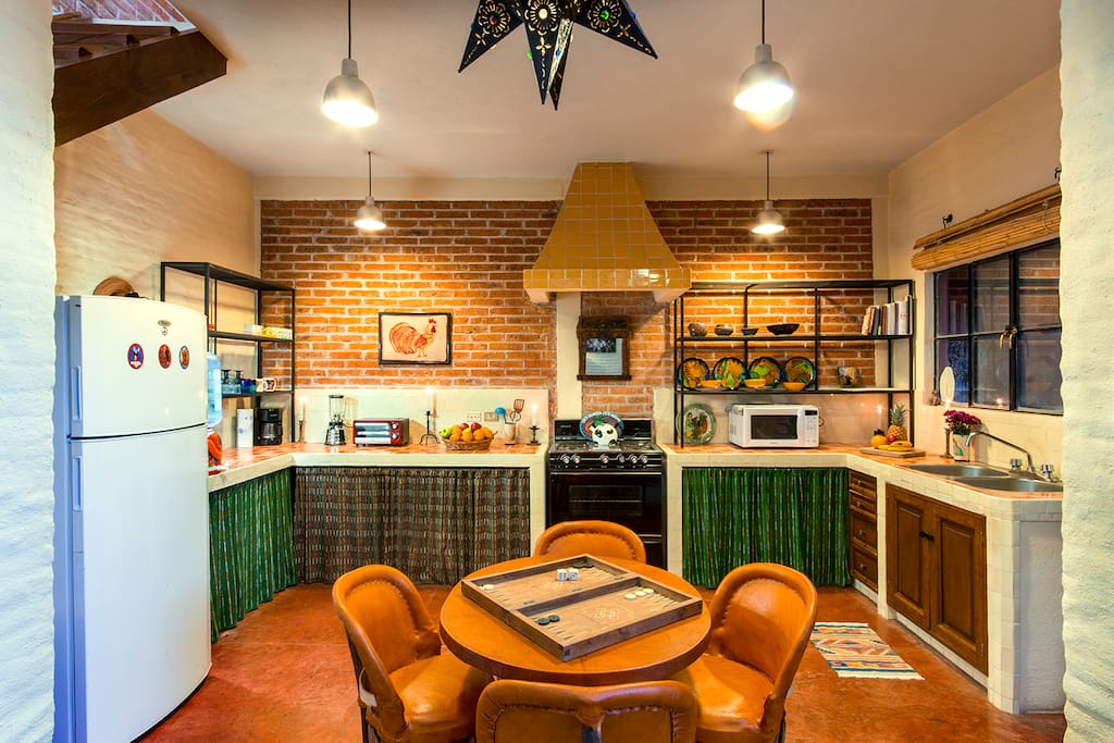 Open plan kitchen features a glass door to an outdoor patio that seats four.