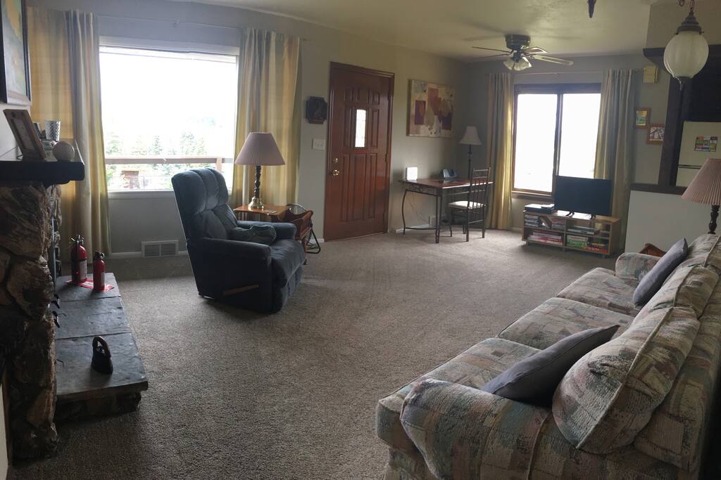 The newly carpeted living room invites you to sit, relax, and enjoy the view!