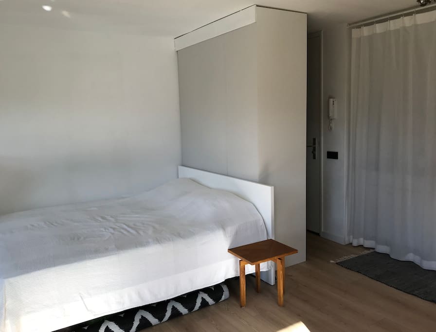 Bed and walk-in closet/entrance of the apartment.
1/3 of the closet is for our guests; Iron, hair dryer, luggage scale, hand vacuum cleaner. Clean towels.