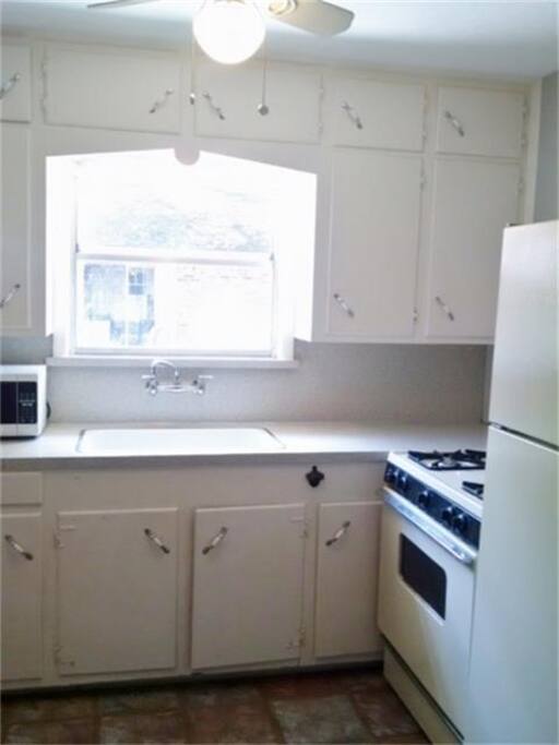 Full kitchen. With dishes, utensils and pans. Microwave and coffee maker.