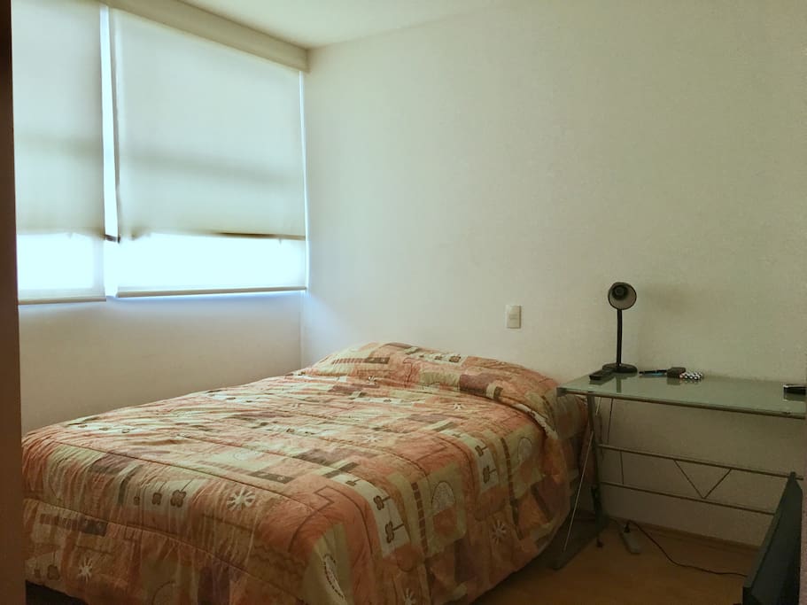 Private room with queen size bed, TV, Apple TV and desk.