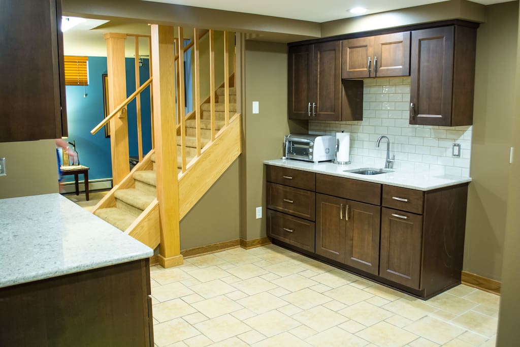 Newly renovated kitchenette includes microwave, toaster oven, sink, and two mini fridges