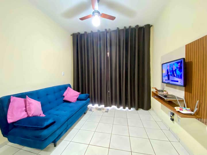 Dhomë ndenjjeje me divan krevat, Smart TV me Netflix dhe ventilator tavani.