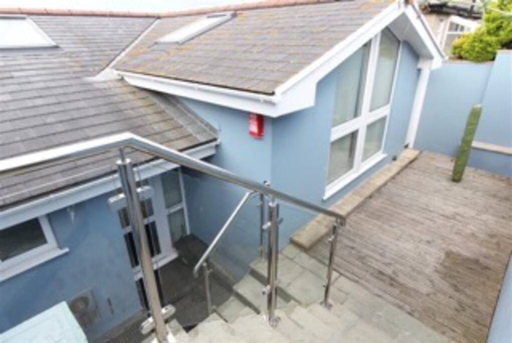 Steps down from road to front door.