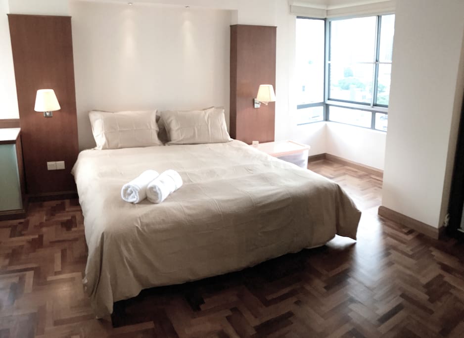 The master bedroom with a king sized bed & plush pillows.