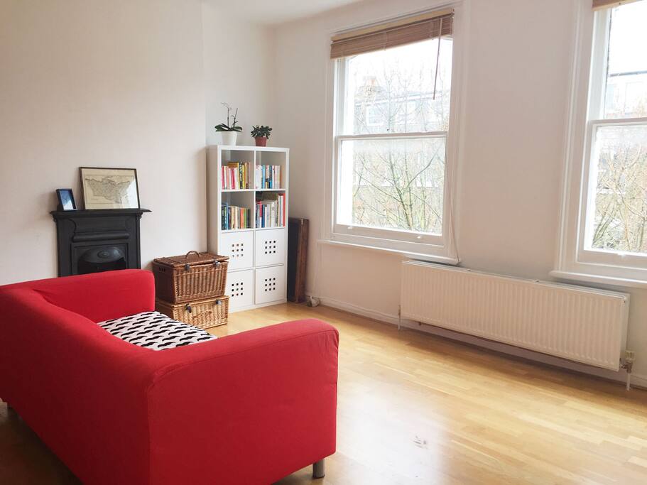 Bright and cozy living room with modern wooden floor and heater
