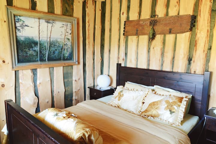 1st floor bedroom in the Summerhouse of "Branki" household with access to private guest kitchen, bathroom and large living room with a masterpiece stone fireplace. 

Photo by Linda Vorpe photography.