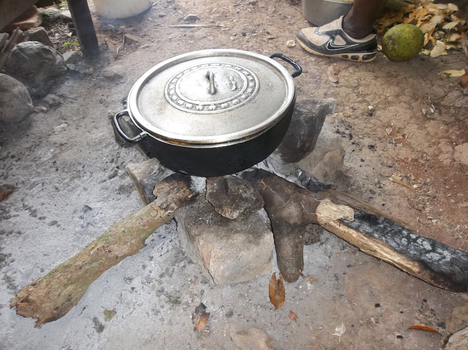 Ital cooking outside on charcoal fire.