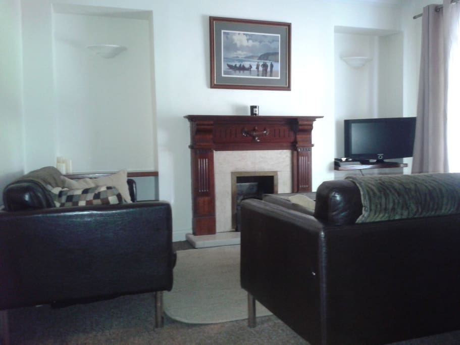 Large sitting room area with TV and gas fire